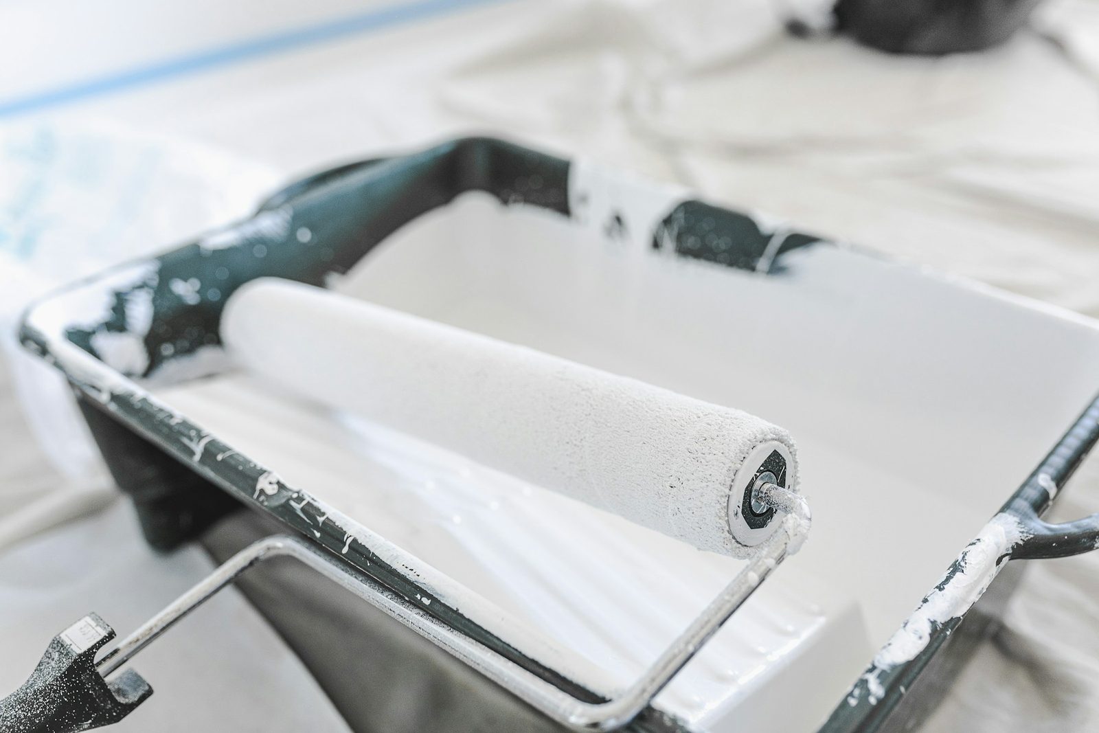 Close-up of a paint roller applying a coating to a flat surface