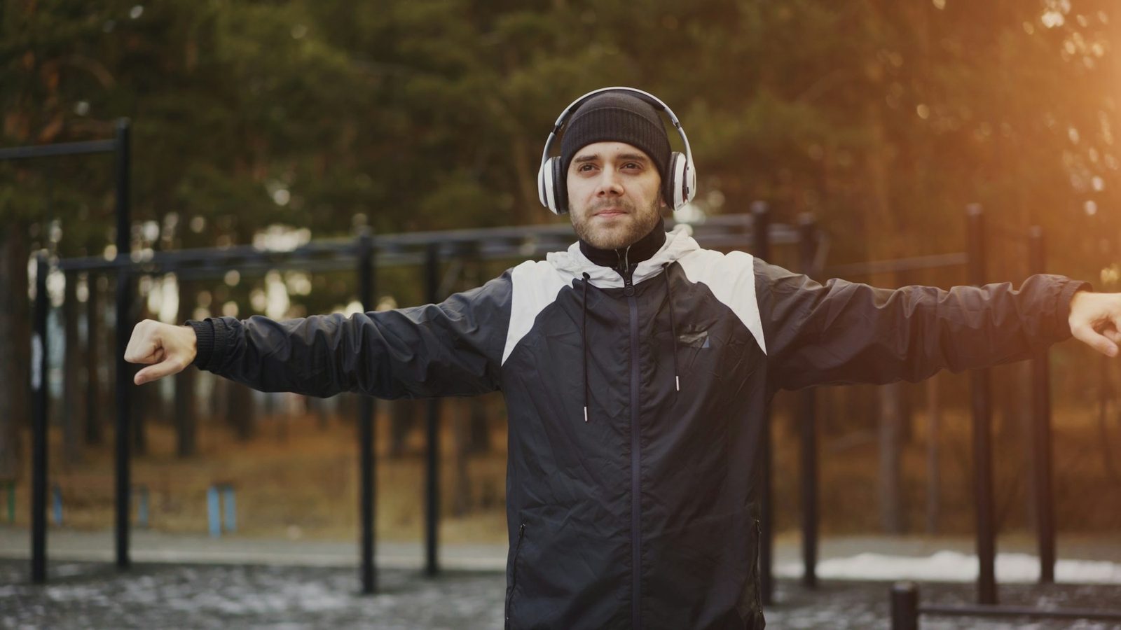 Person stretching their arms and shoulders outdoors before exercise