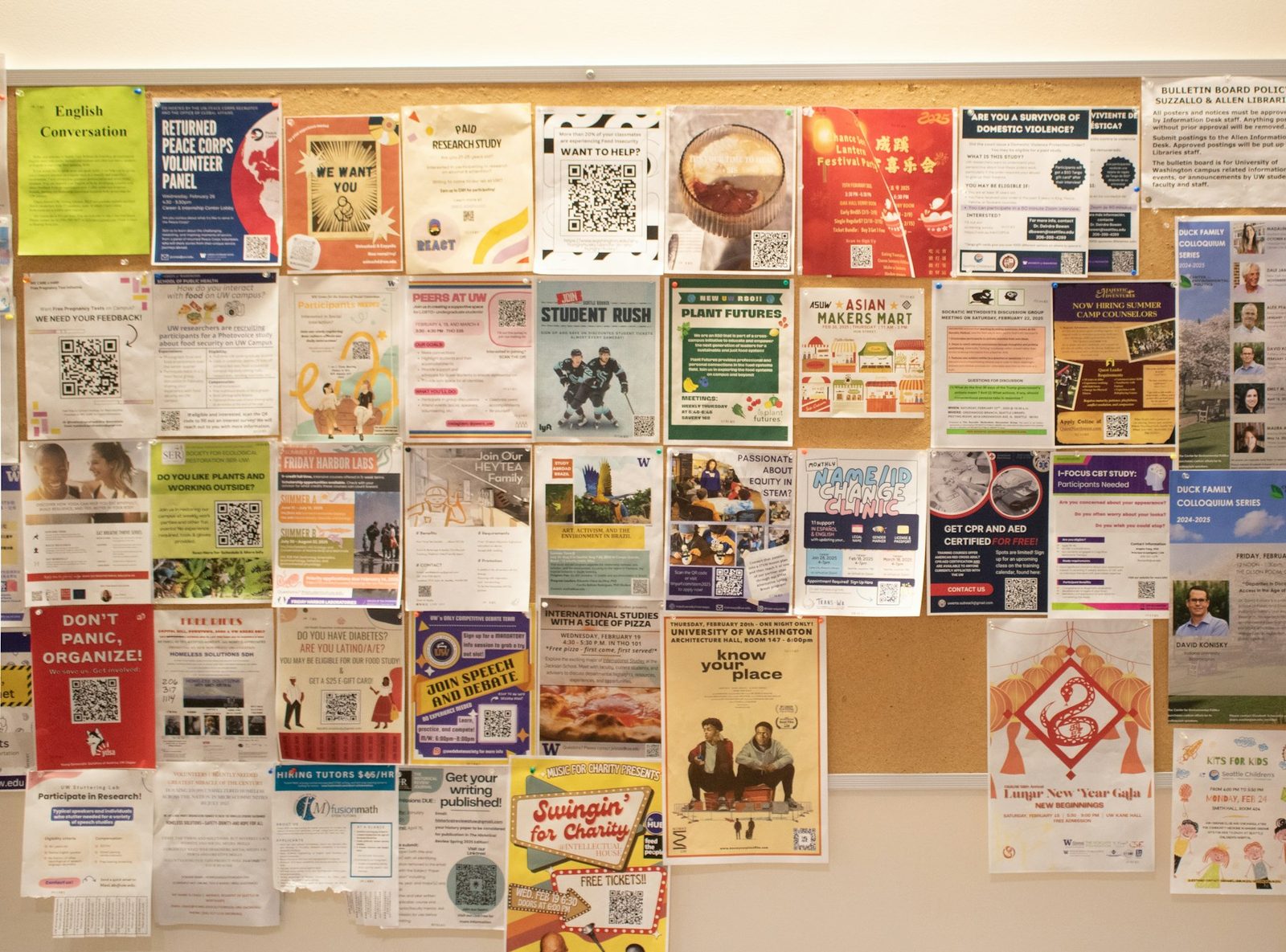 Corkboard covered with pinned flyers and notices