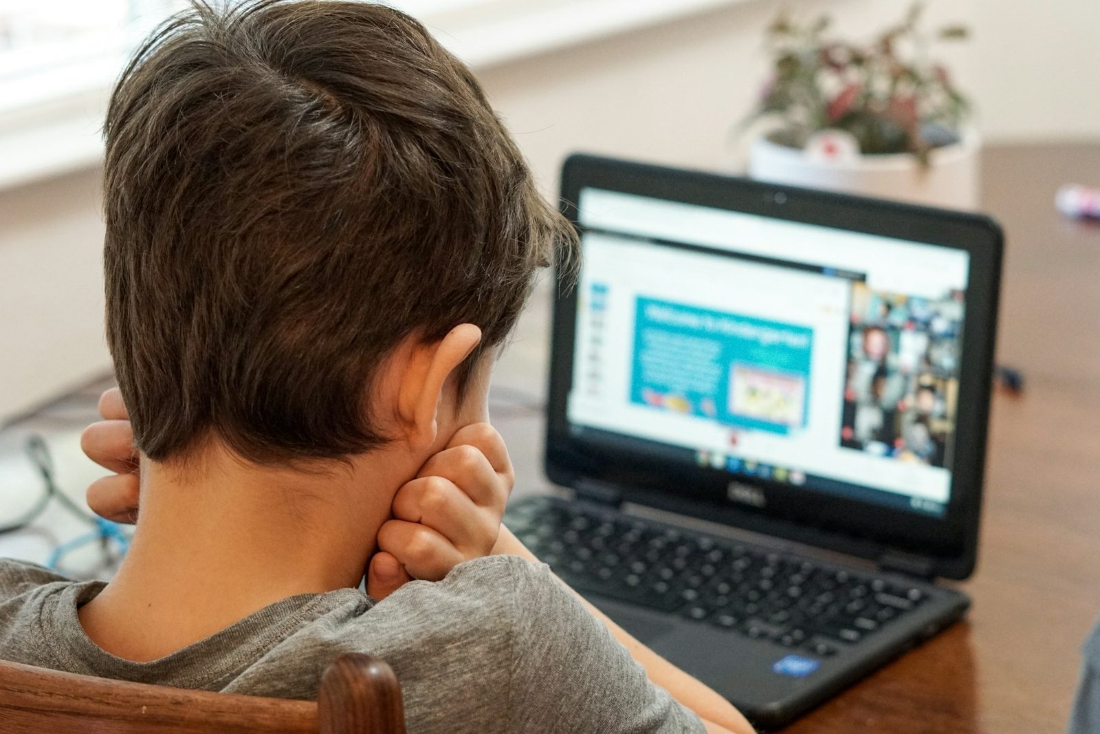 A person reviewing footage on a laptop computer