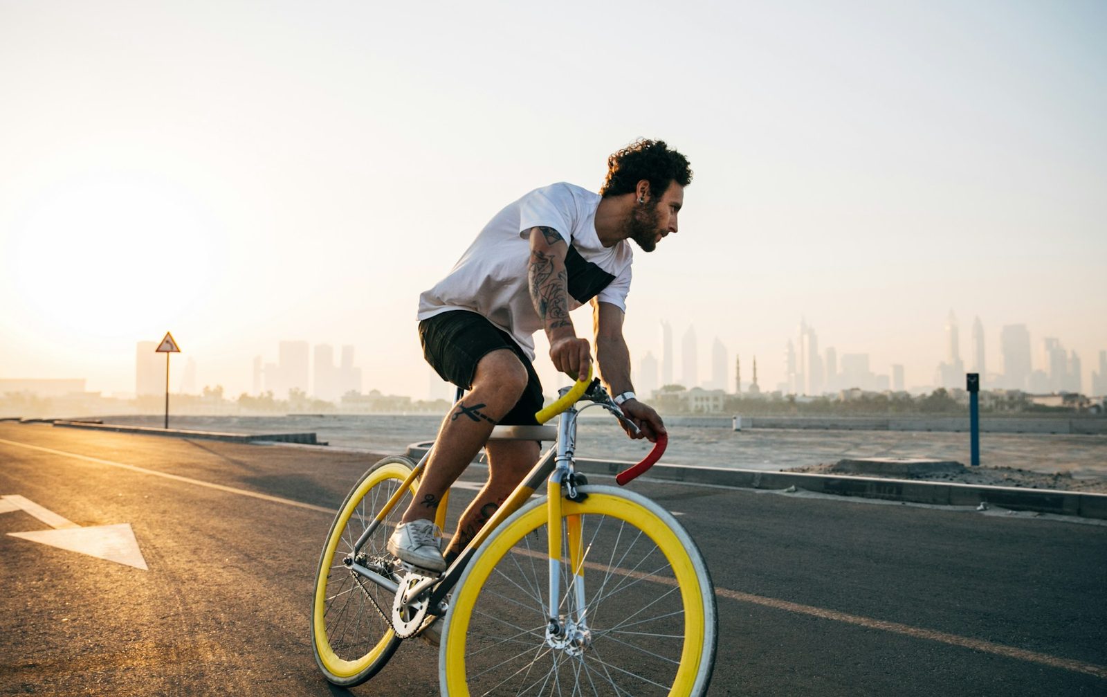 A man riding a bicycle on a road during the day