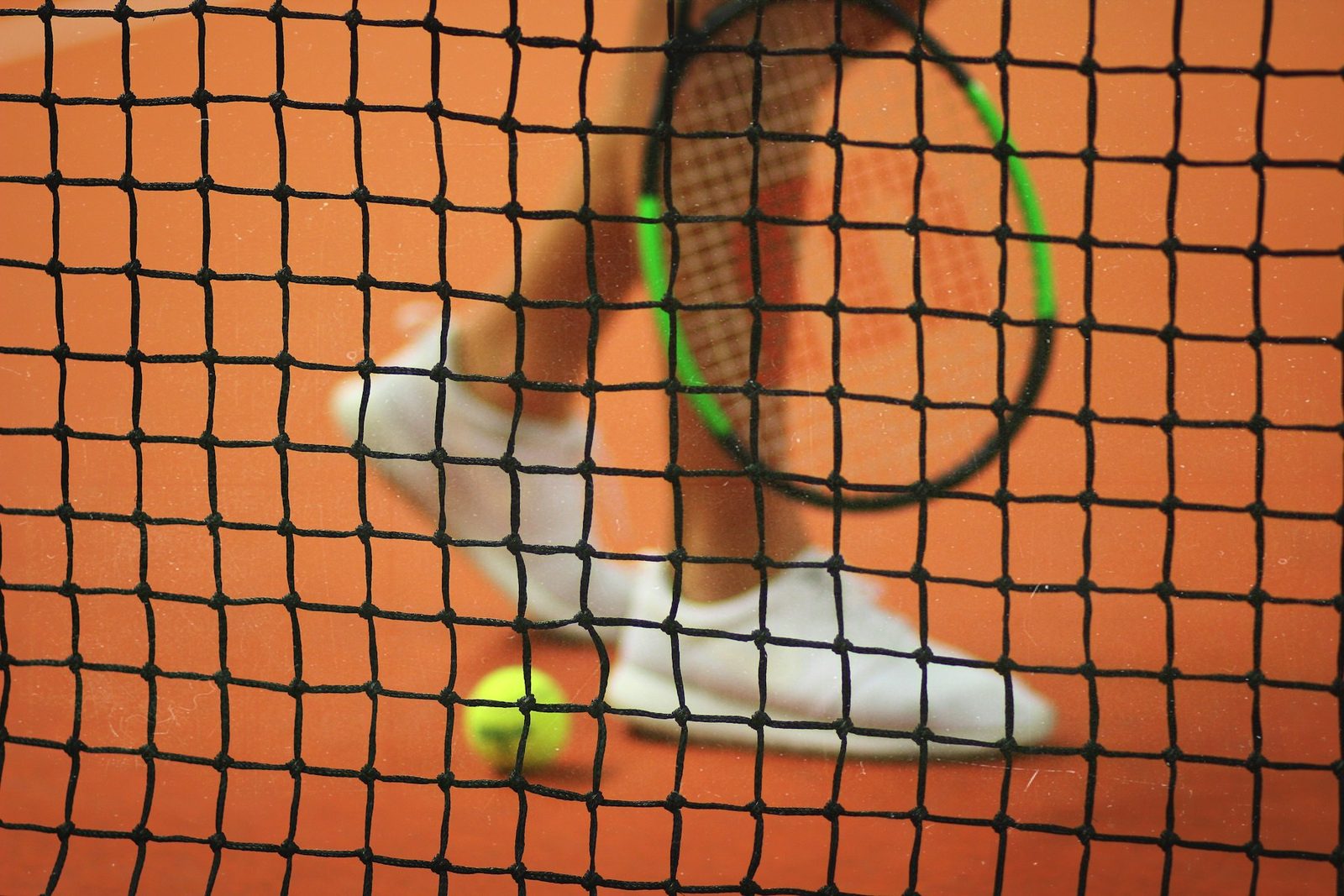 Player holding a racquet in the ready position before the serve is struck