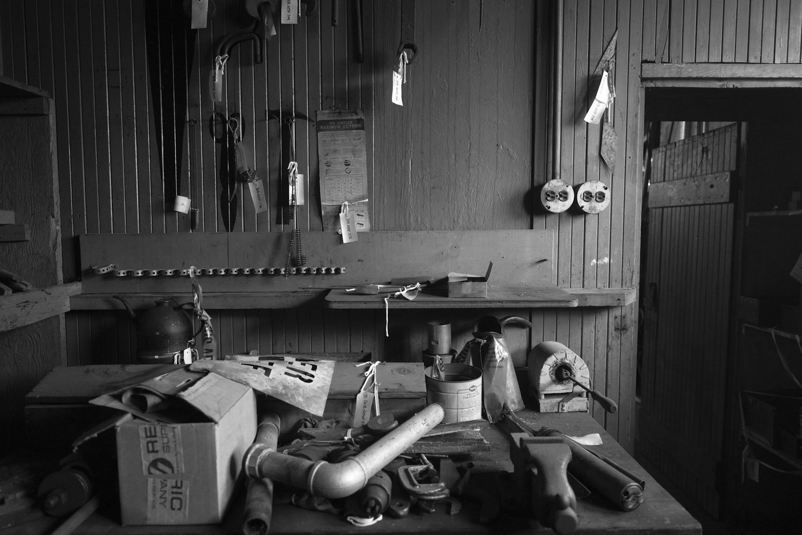 Cluttered workbench covered with hand tools and workshop supplies