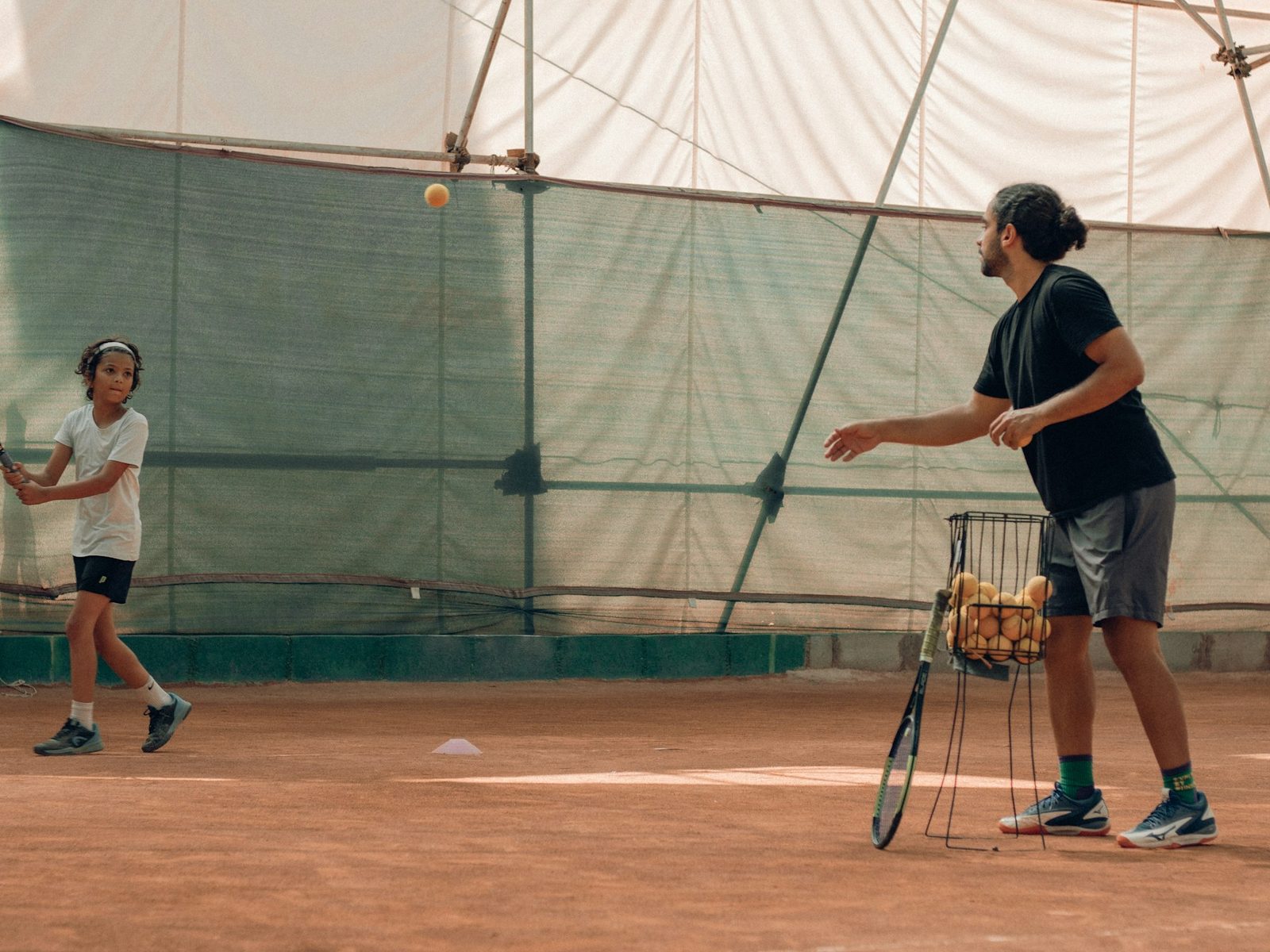 Two people playing tennis together