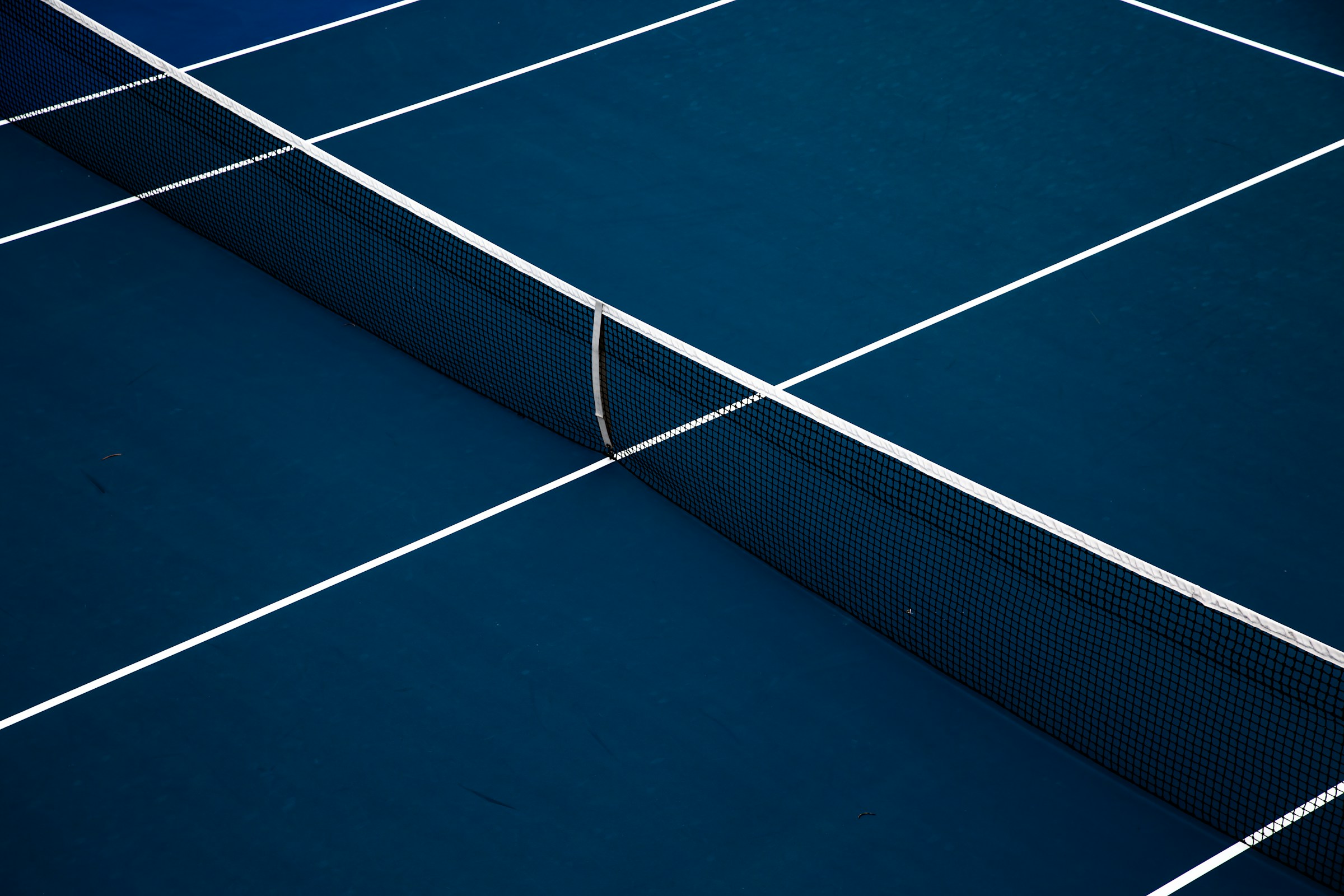 Empty tennis court at sunset