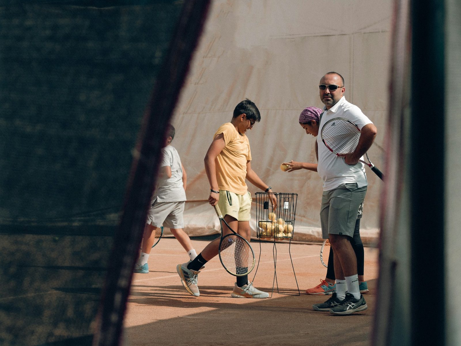 Group of players gathered together around a tennis racquet on court