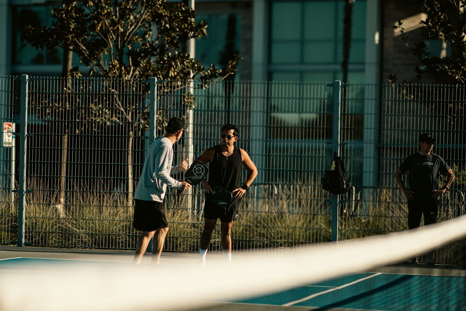 Players standing together on a tennis court during a group session