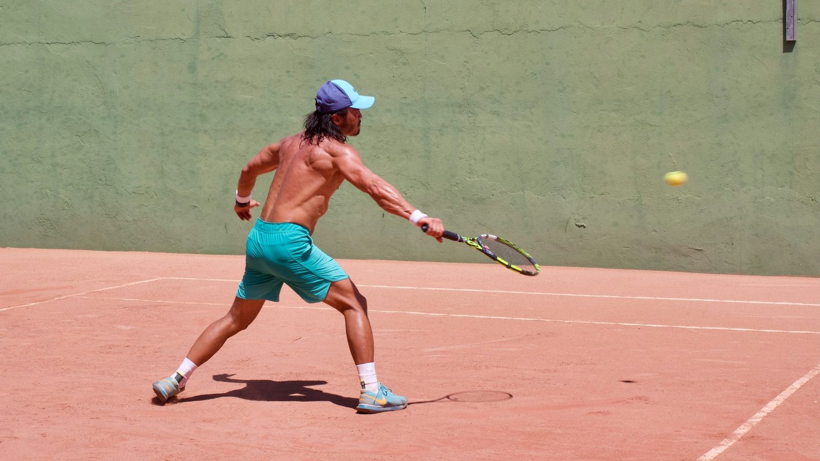 A man playing tennis on an outdoor court