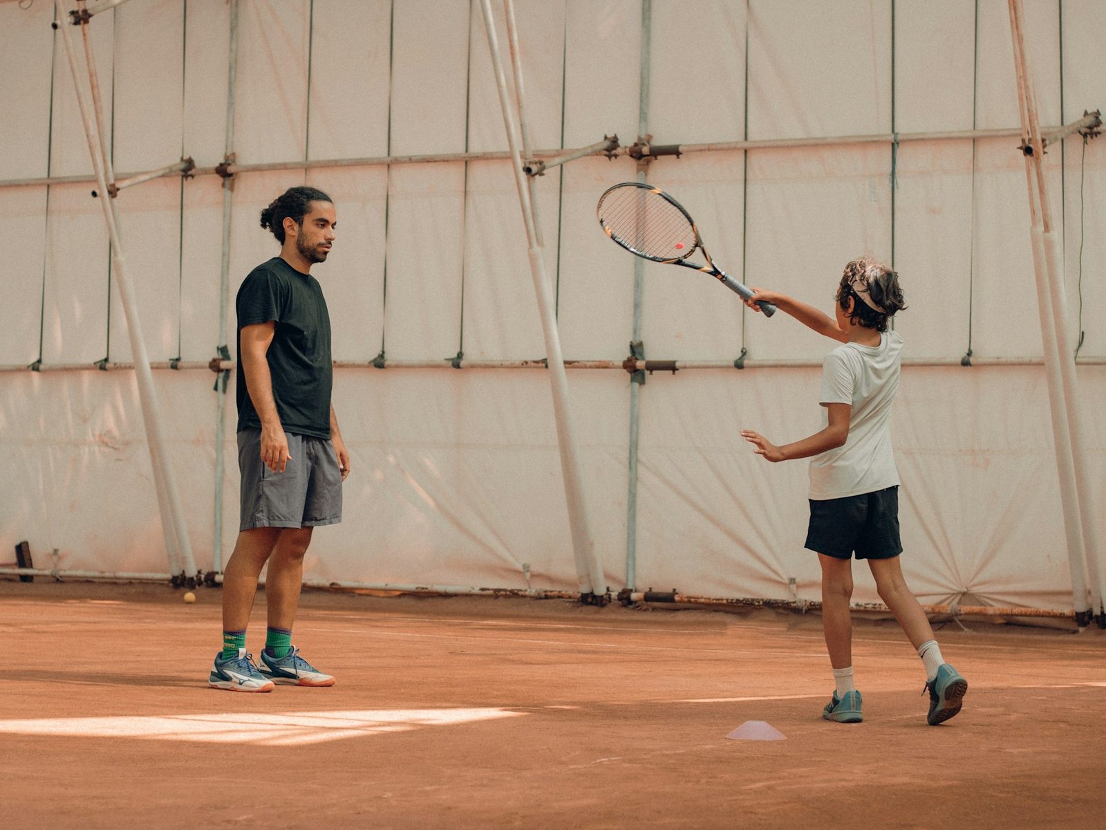 Two players rallying against each other on a tennis court