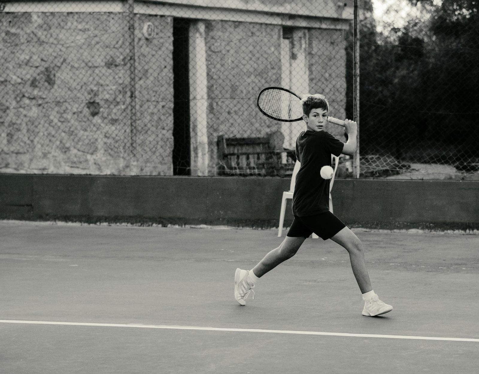 Player holding a racquet overhead on a tennis court