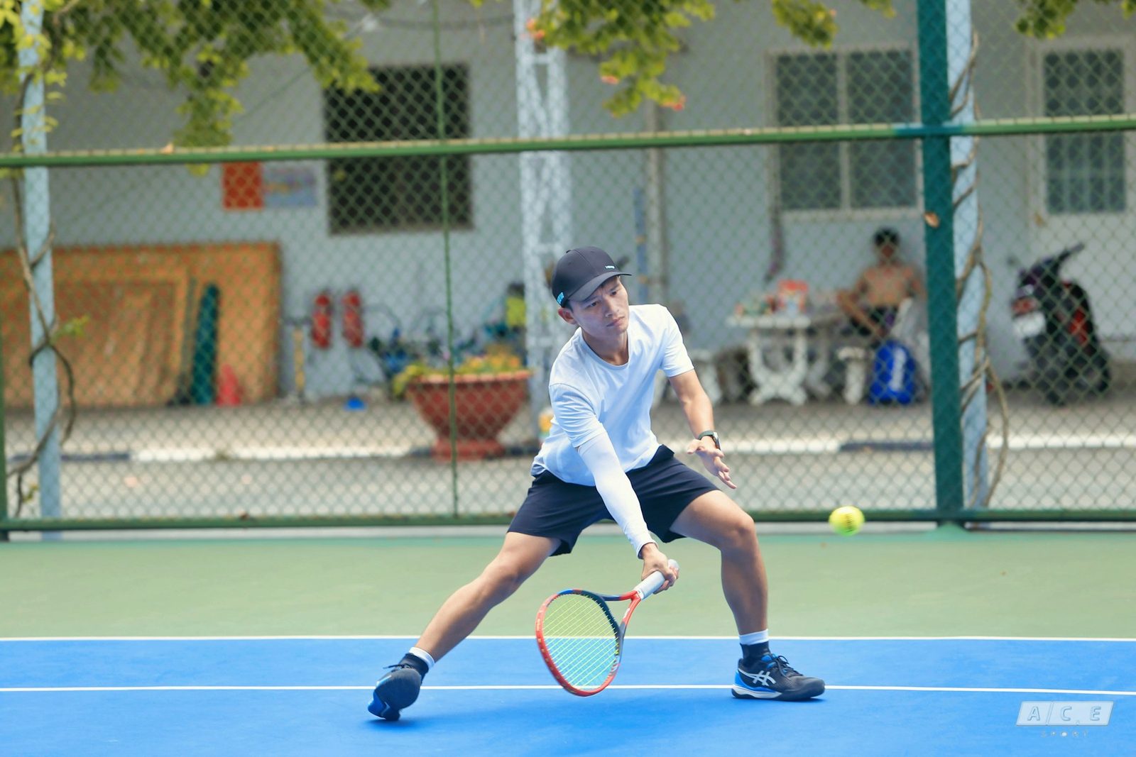 Young man holding a racquet on a tennis court
