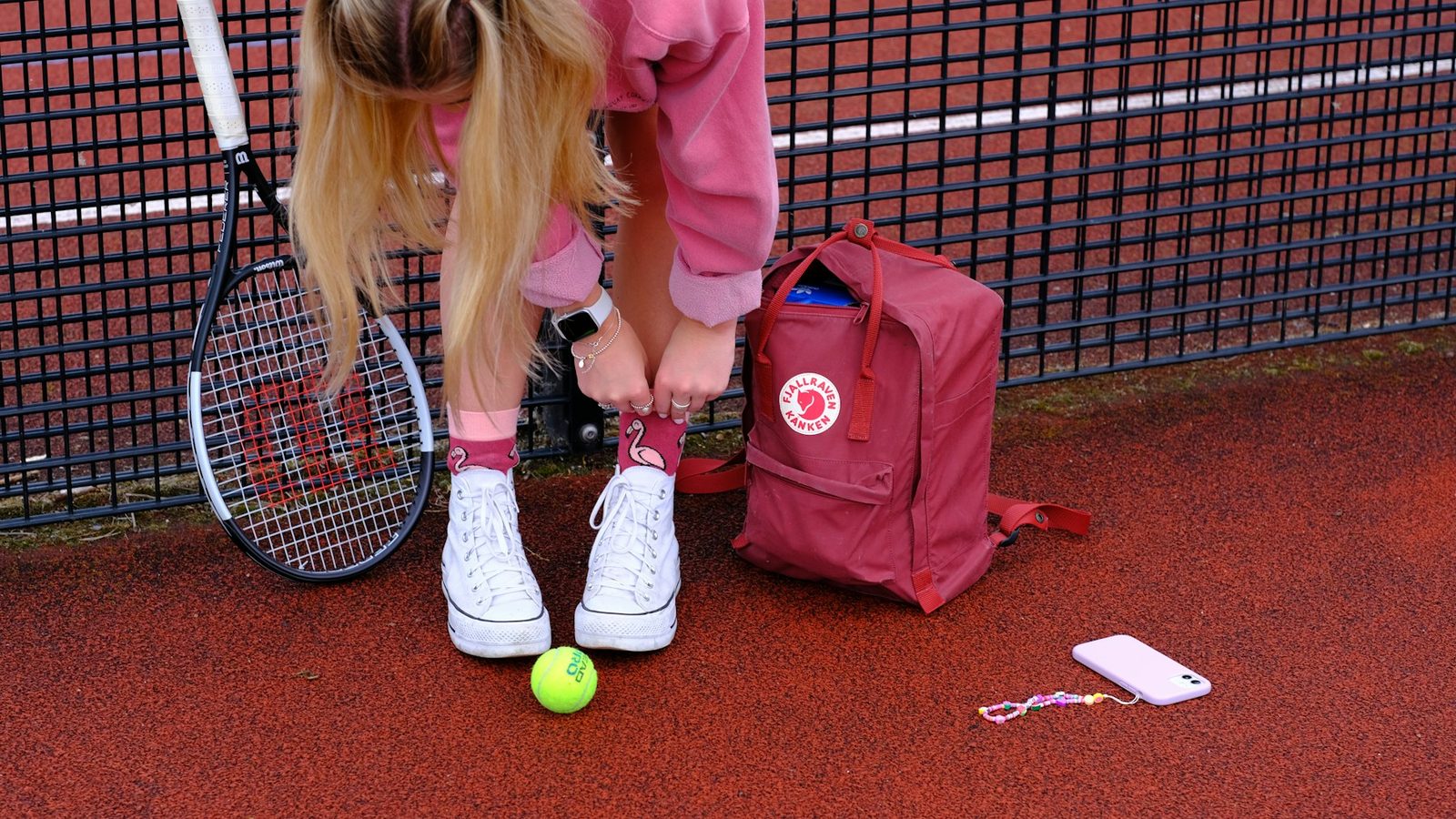 A young girl playing tennis on a tennis court