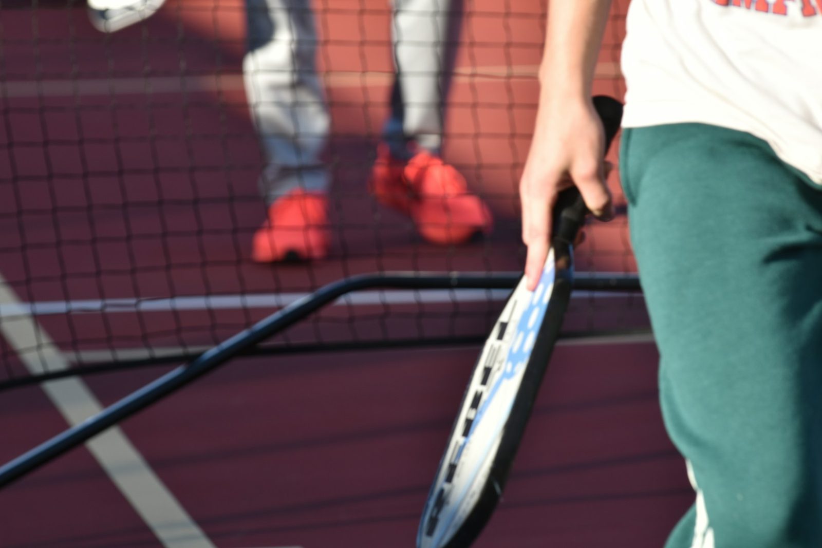 A tennis player holding a racquet on court