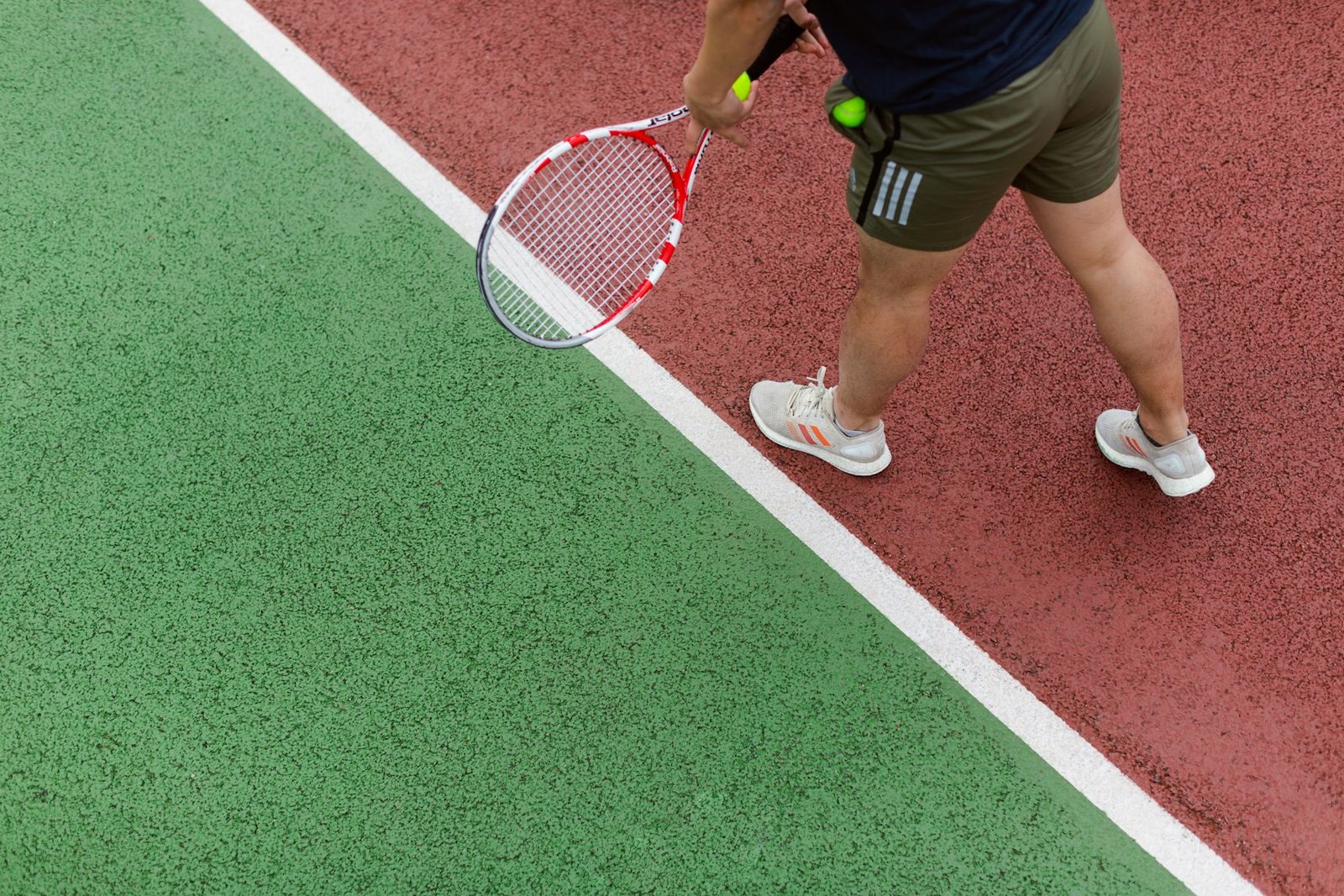 Player moving across the court holding a tennis racquet