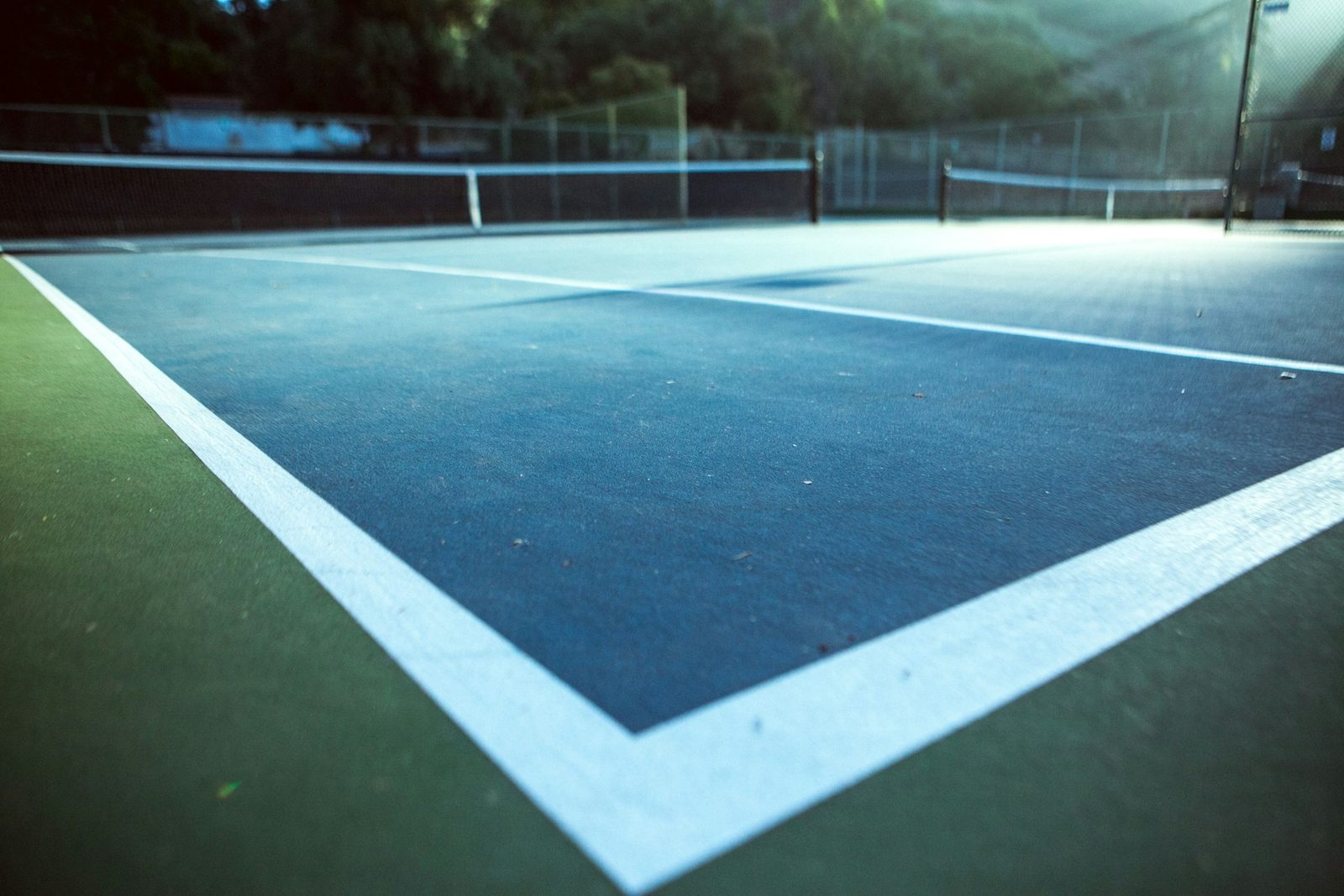 A blue and white tennis court photographed from above