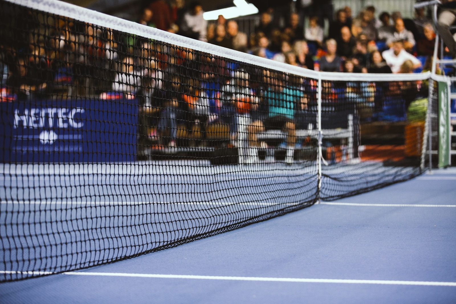 Black and white view of a tennis net across the court