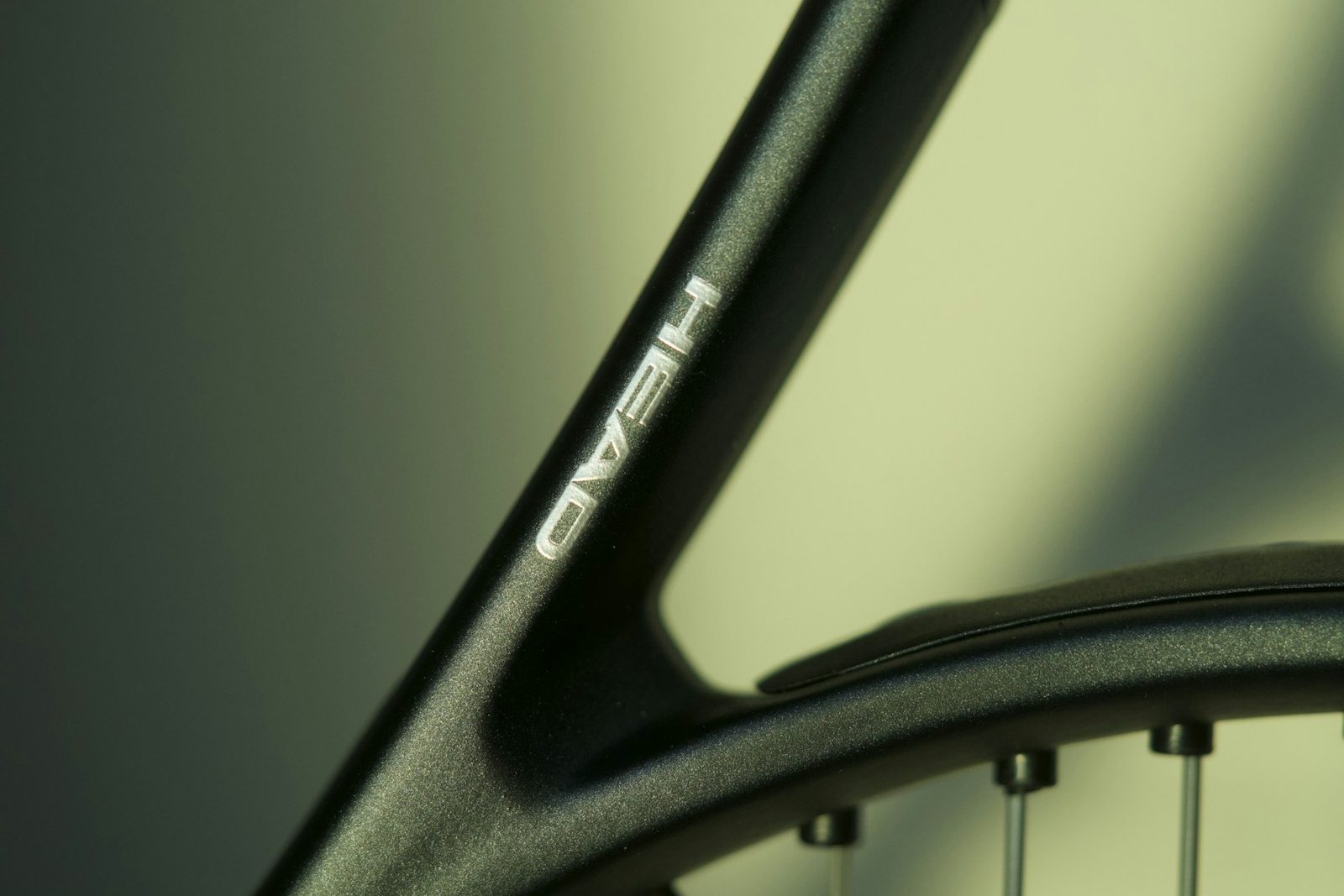 Close view of a black tennis racquet head