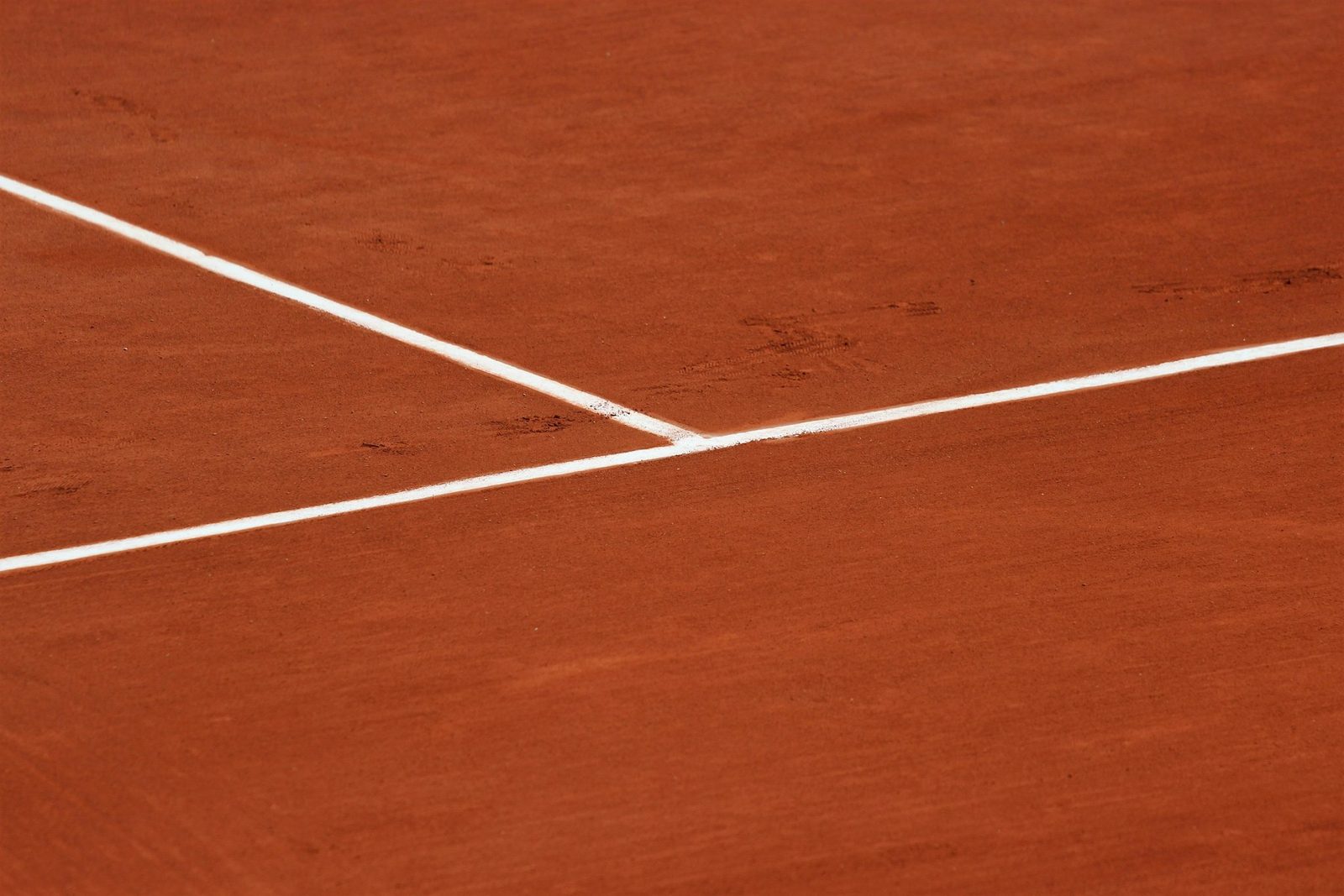 A white court line marked on a clay surface