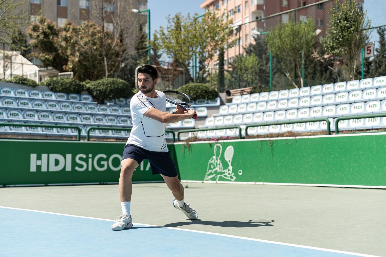 Male tennis player poised for a powerful return on an outdoor court
