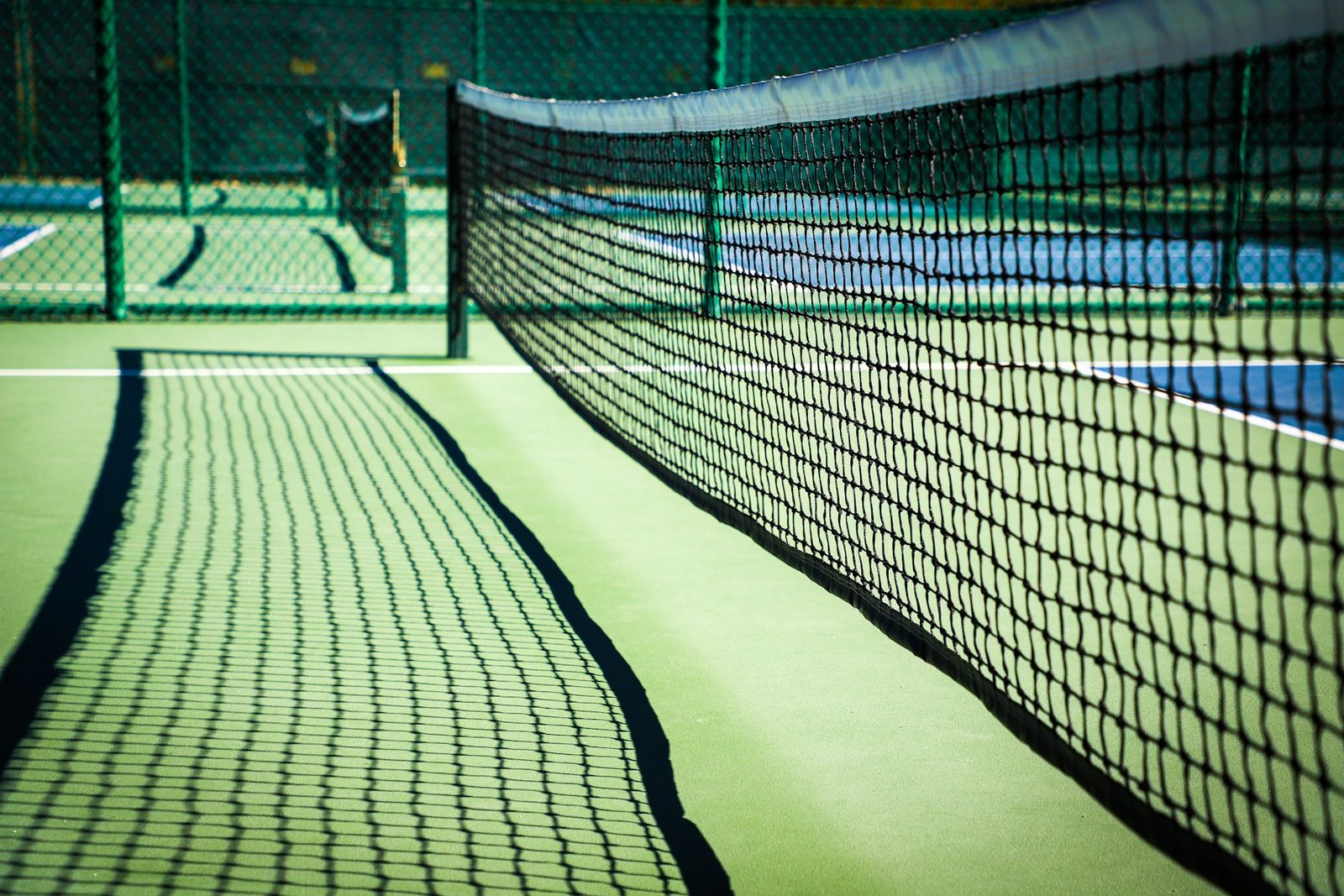 Black and white view of a tennis net across a court