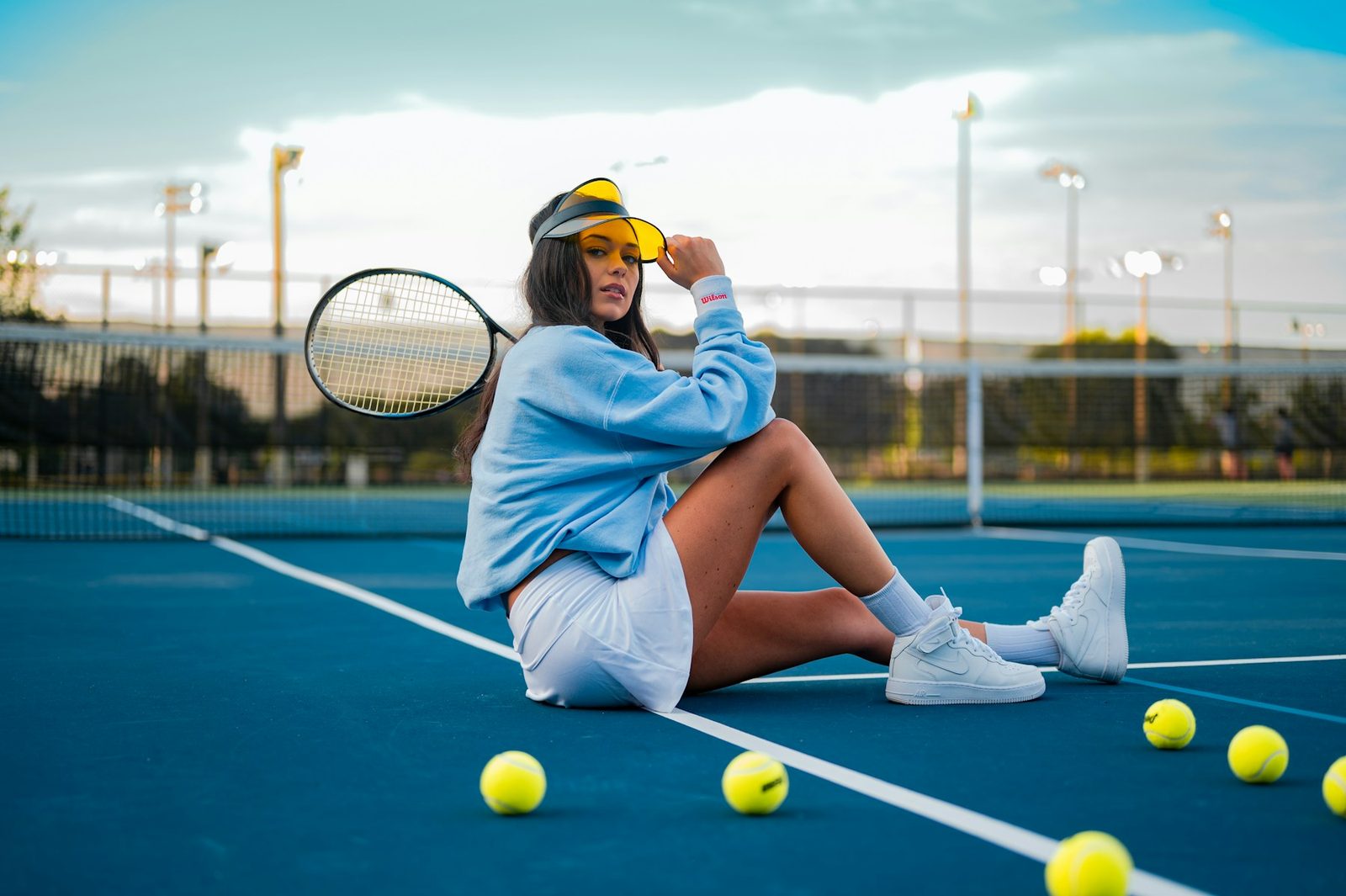 Player pausing on a tennis court between lesson drills
