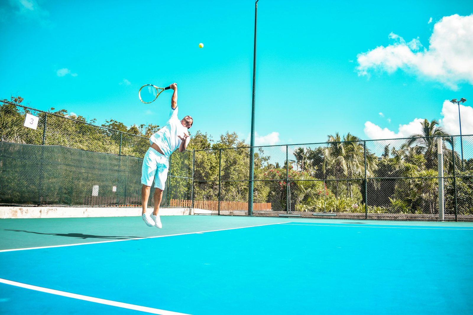 A person playing tennis on court