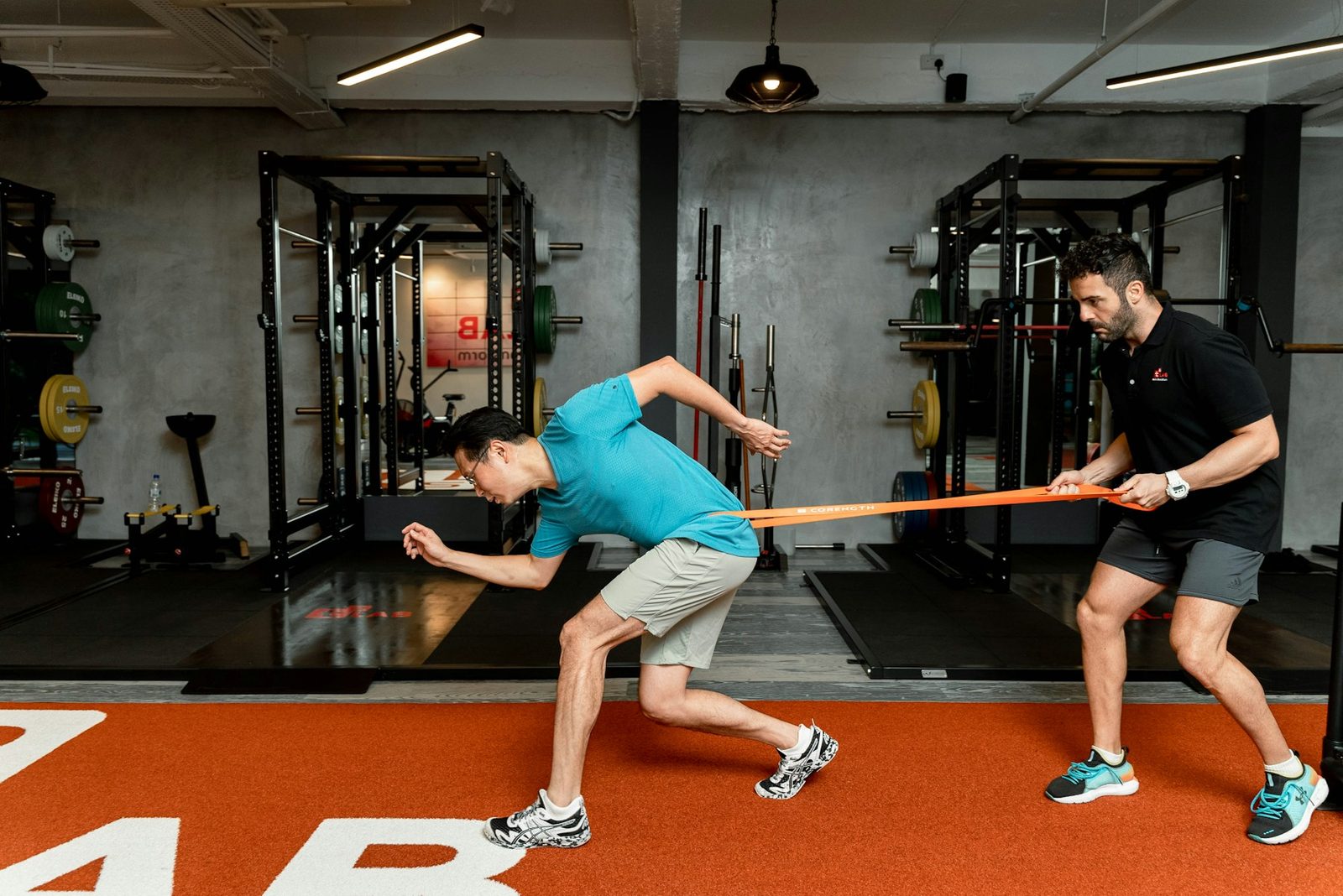 A man working against a resistance band during training