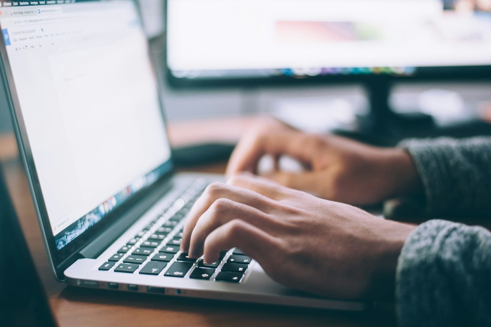 A person using a laptop to complete an online form