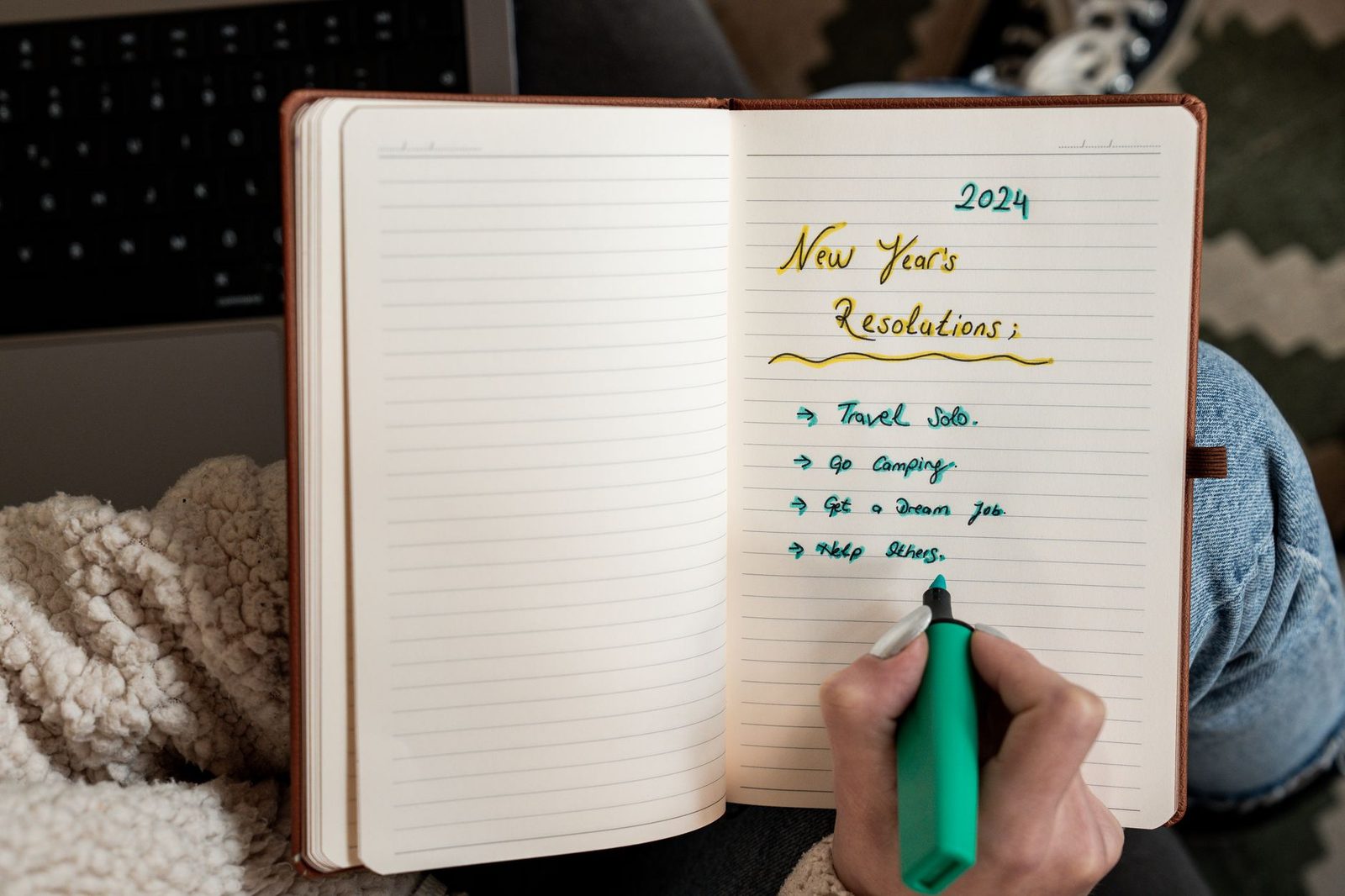 A person writing goals in a notebook