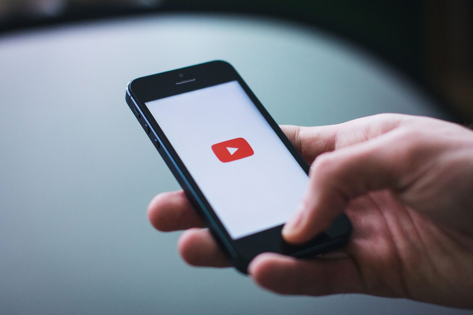 Close view of a hand holding a smartphone playing a video