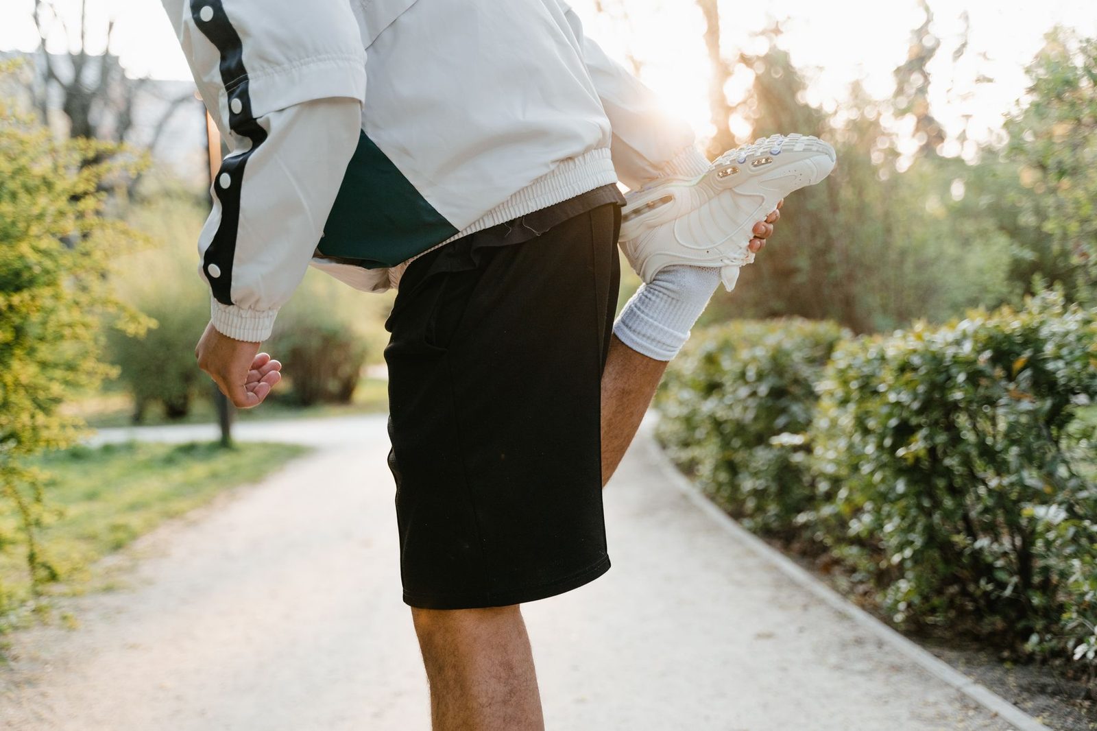 Close view of a person stretching a leg in a sunny park