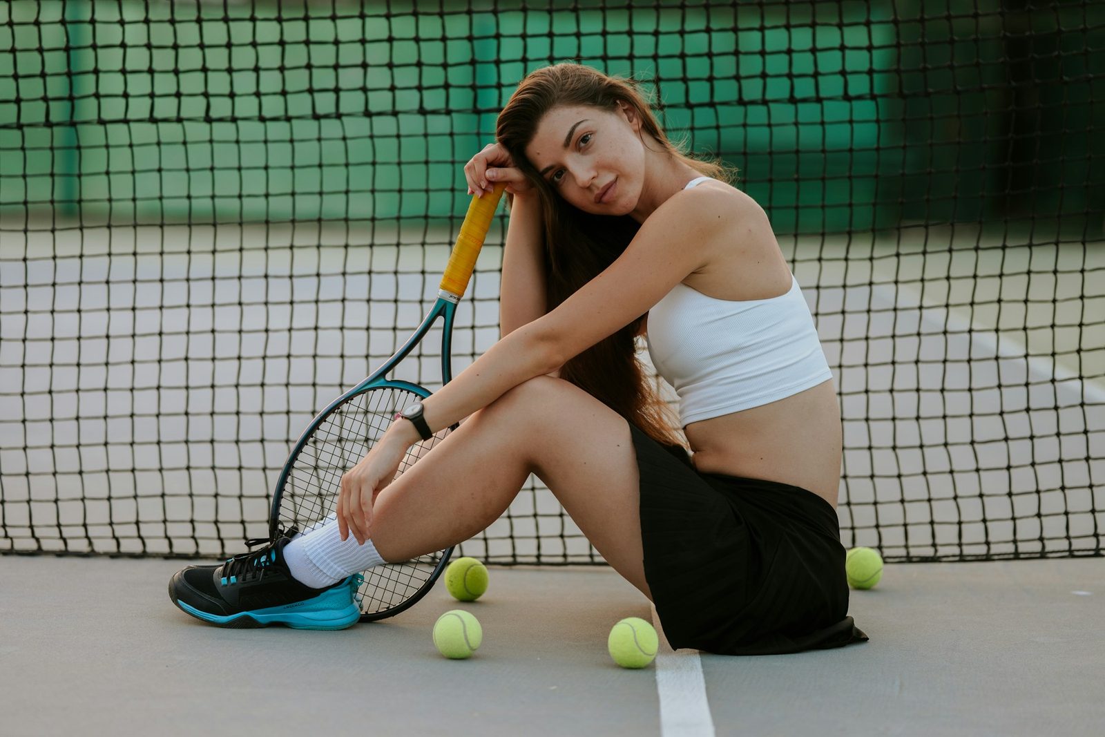 A tired tennis player resting on court between points