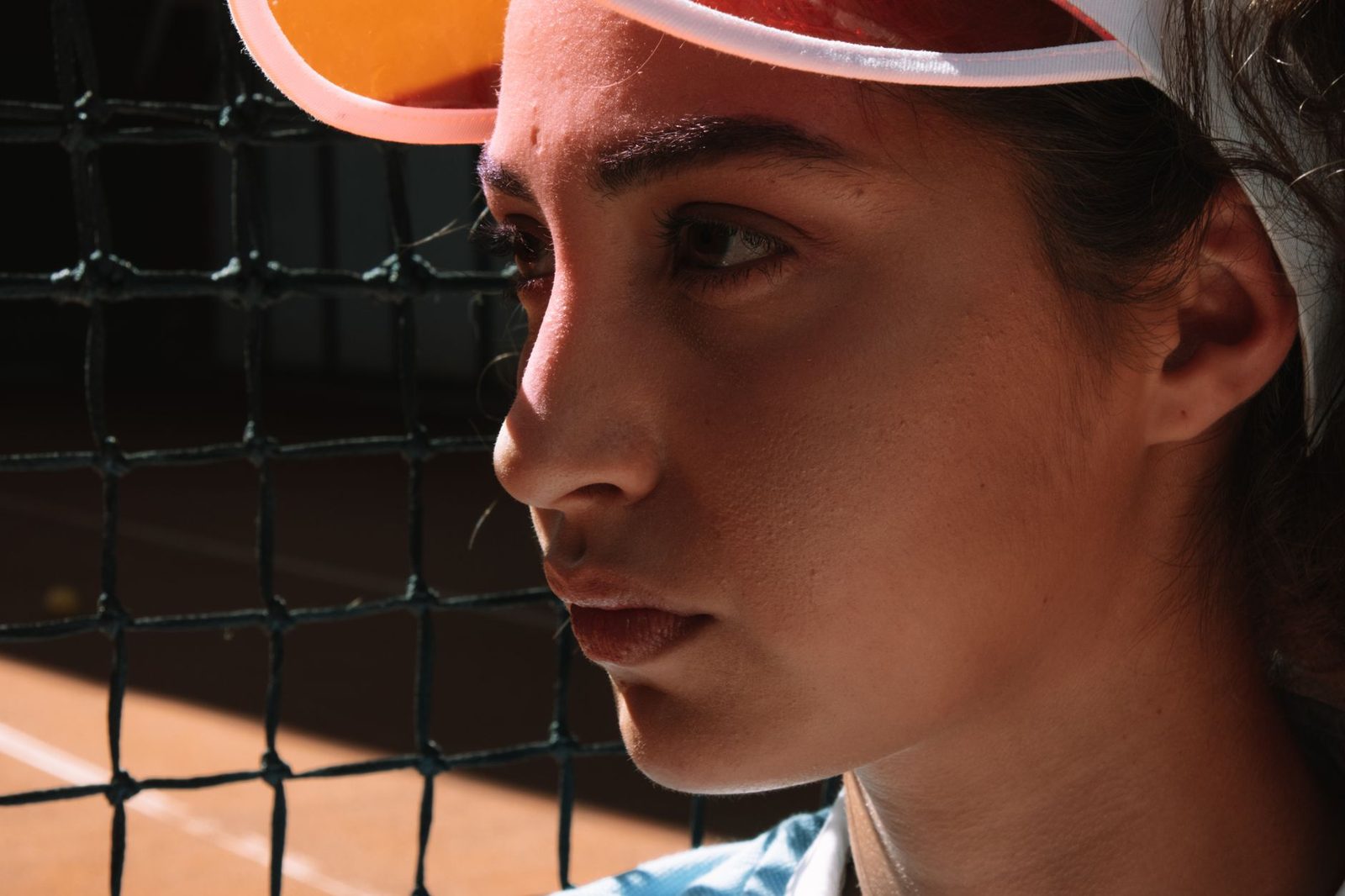 Close view of a female tennis player concentrating beside the net