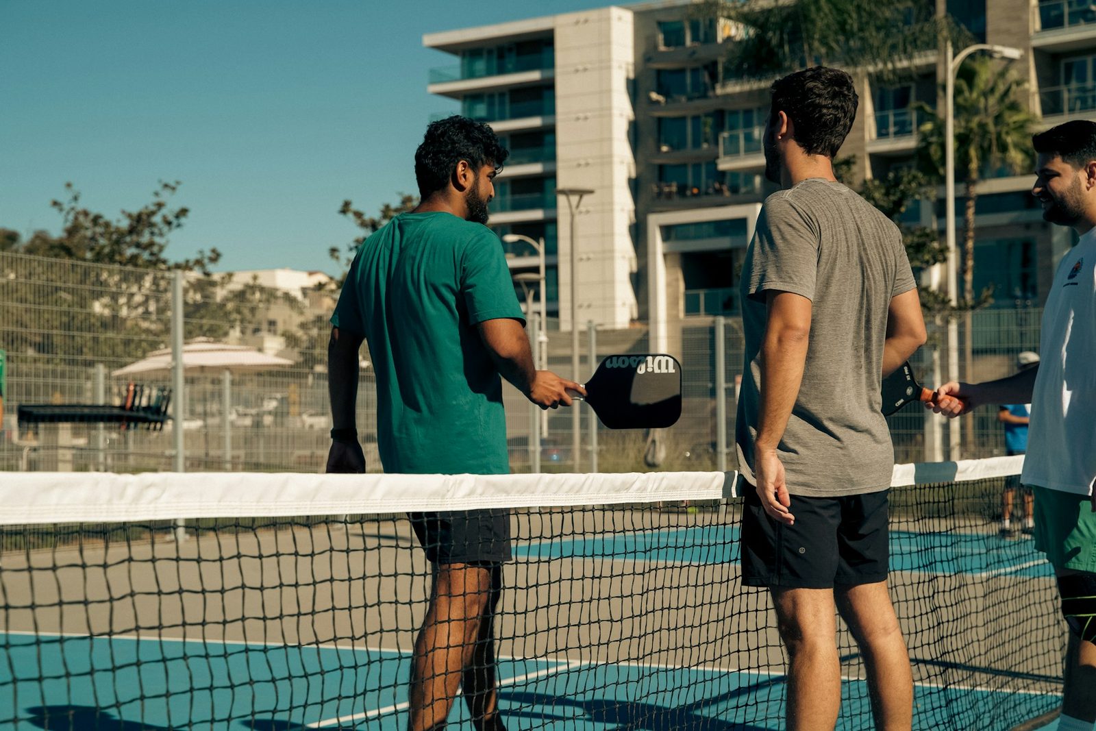 Group of players standing together on a tennis court