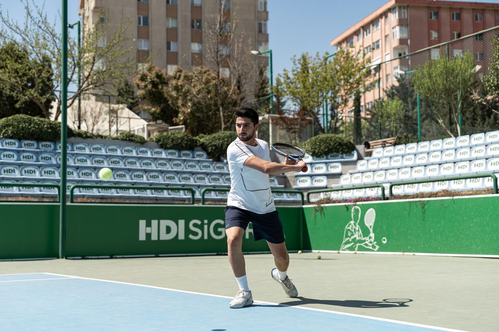 Player hitting a forehand on an urban outdoor court