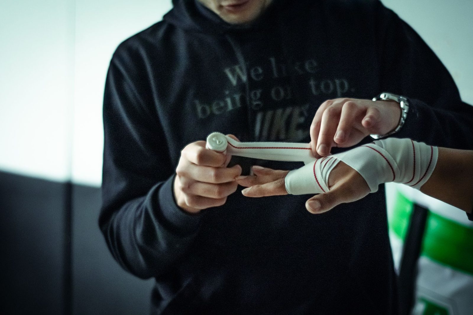 Hands being wrapped with supportive bandages before training
