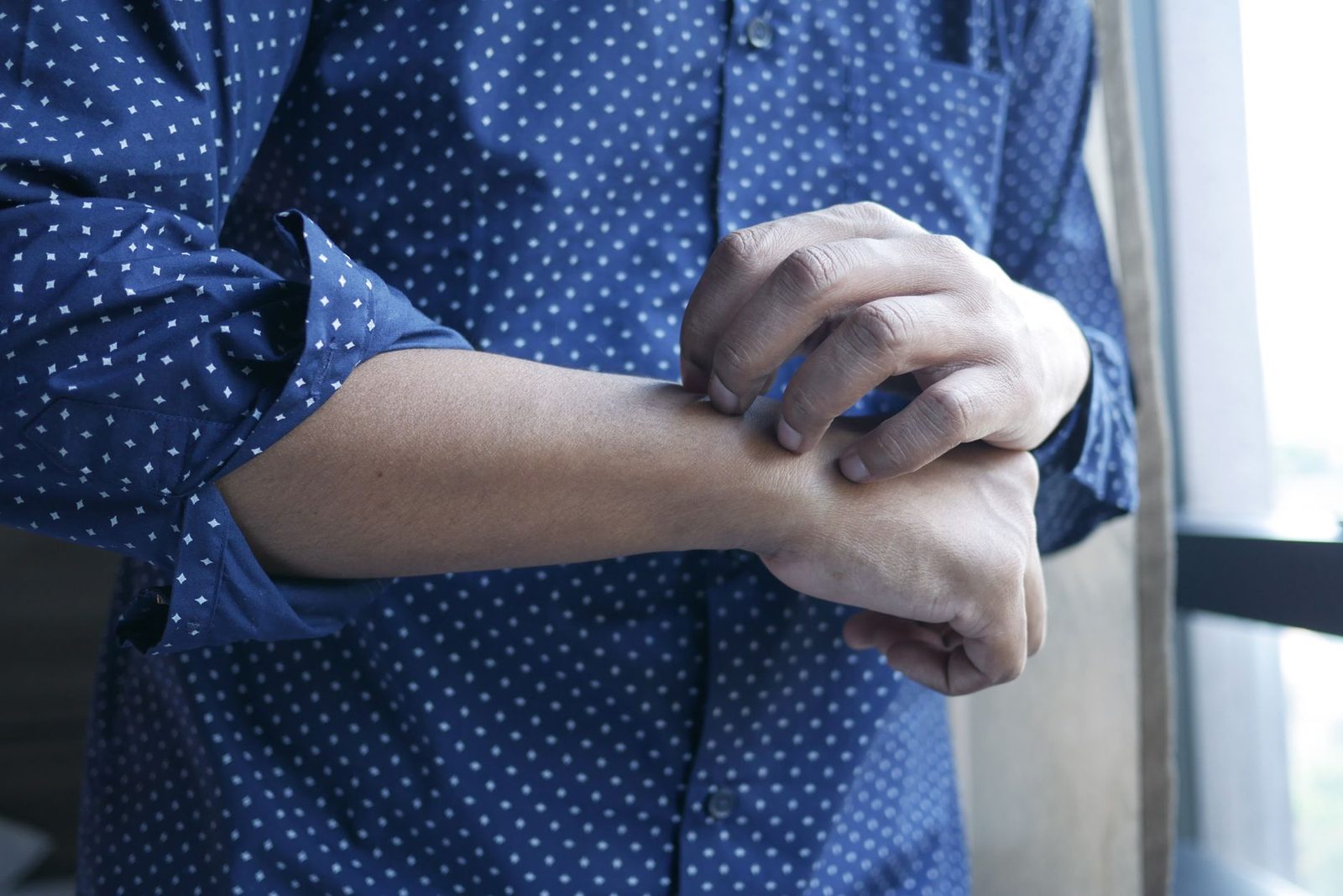 A man holding his forearm, indicating discomfort in the arm
