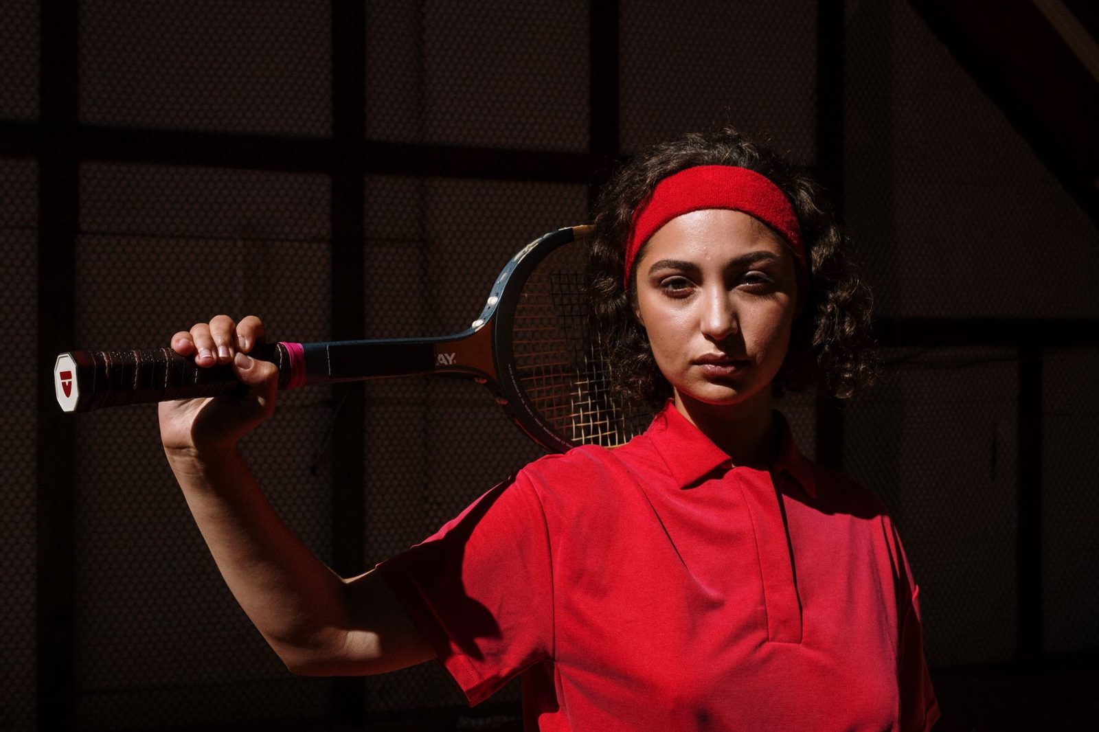 Tennis player holding a racquet, hand visible on the handle