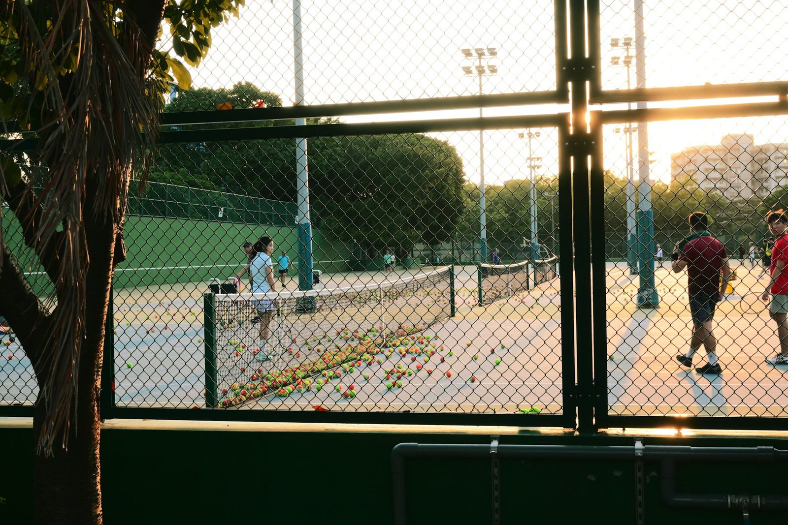 A group of people playing a game of tennis together