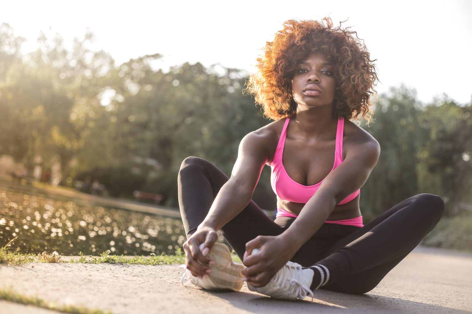 A woman stretching outdoors on a sunny day