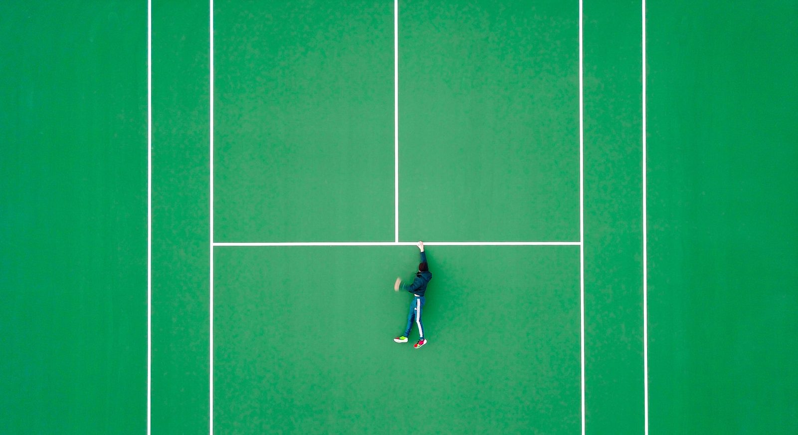 Aerial view of a player resting on a tennis court