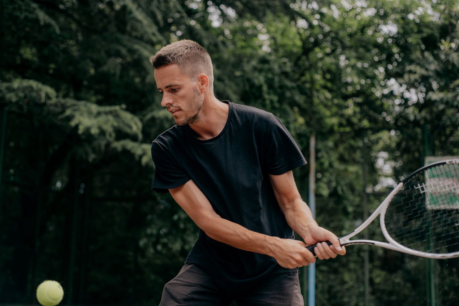 Player focused and set to strike the ball during an outdoor tennis match