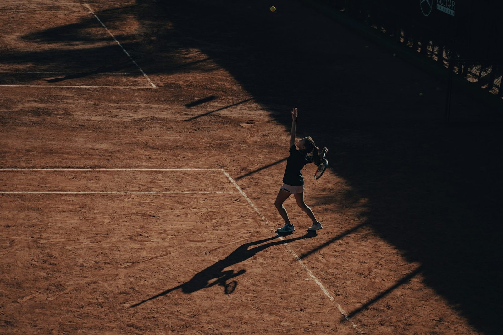 A man playing tennis on an outdoor court