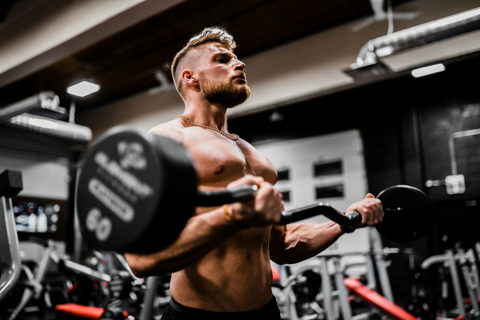 Athlete carrying a dumbbell during a strength and conditioning session