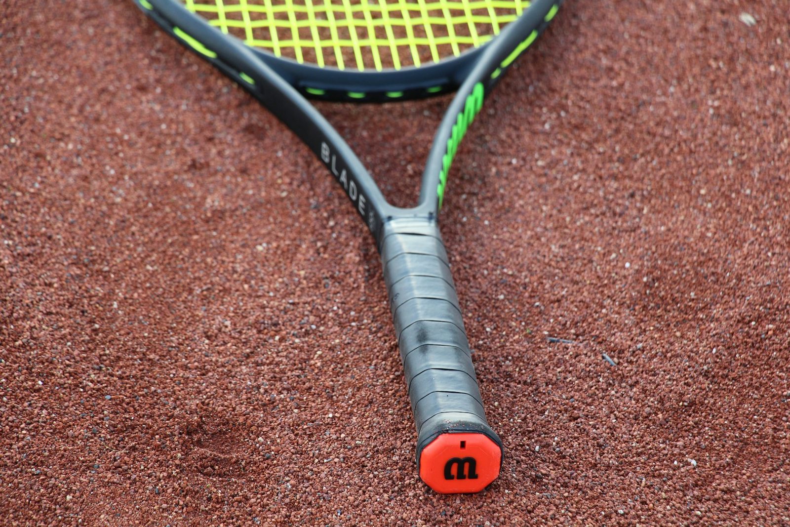 A black and orange tennis racquet