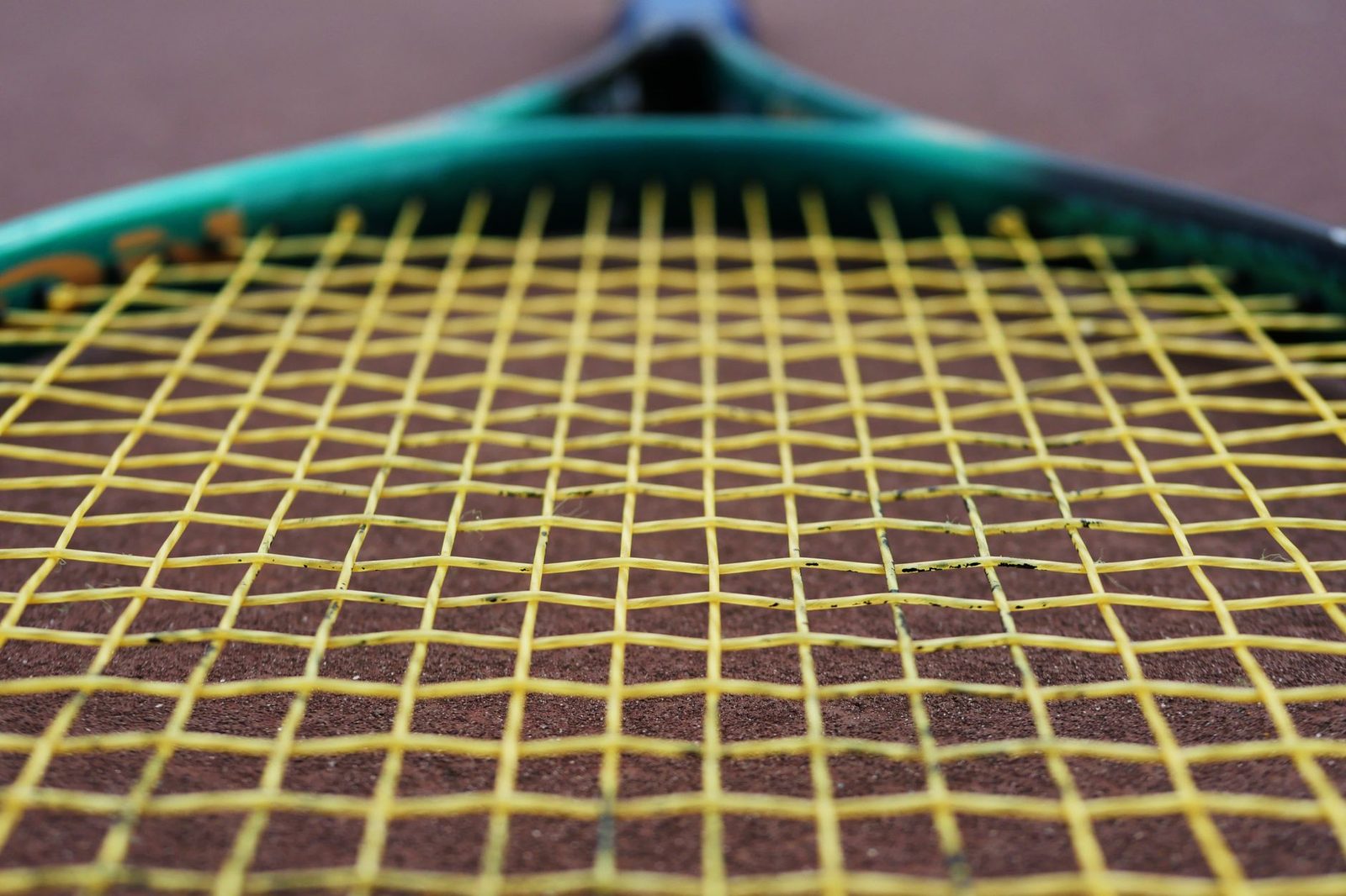 Close view of tennis racquet strings, where the sweet spot sits