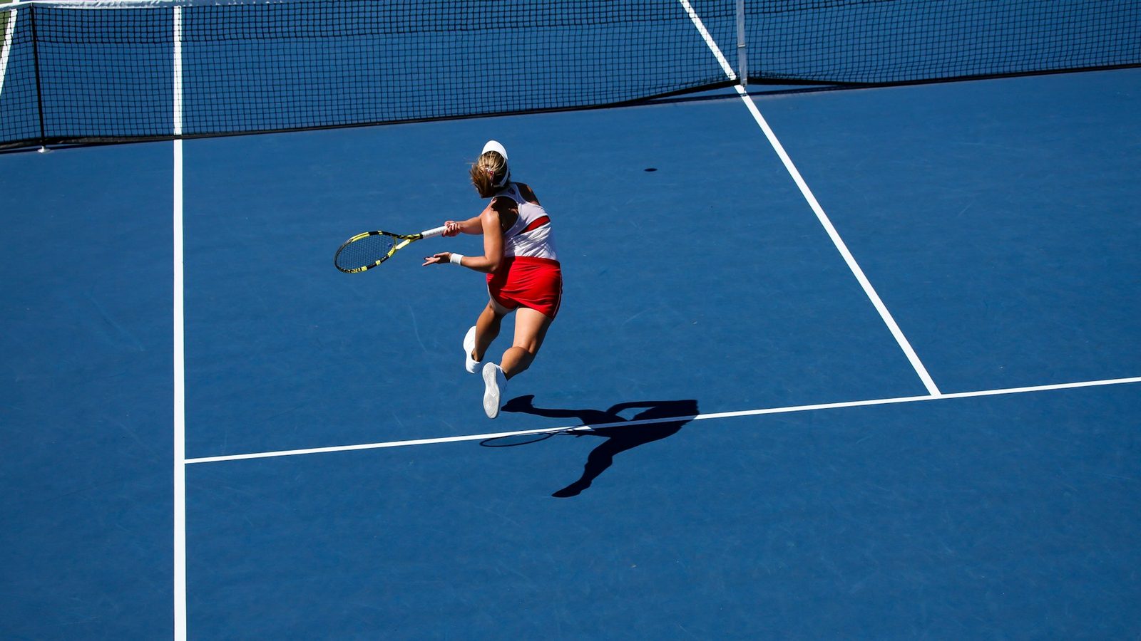 Tennis player reacting to a fast ball during an on-court training session