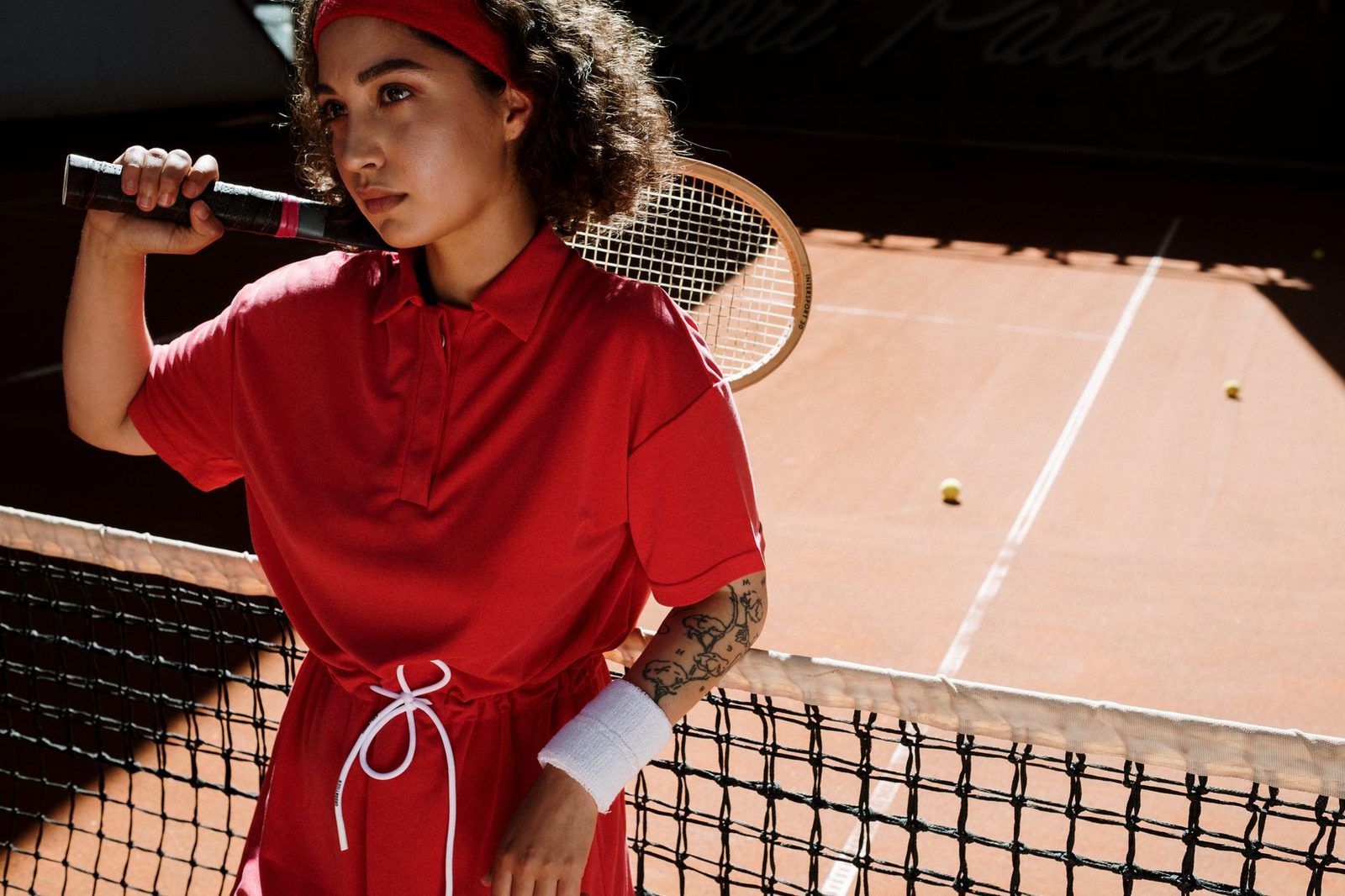 Player holding a racquet on court, focused and waiting to receive