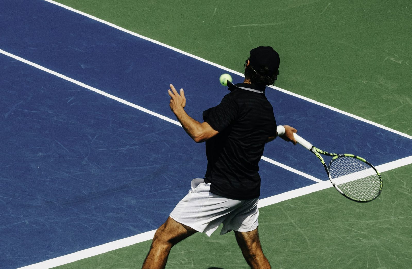 Player holding the racquet at the baseline in the moments before serving