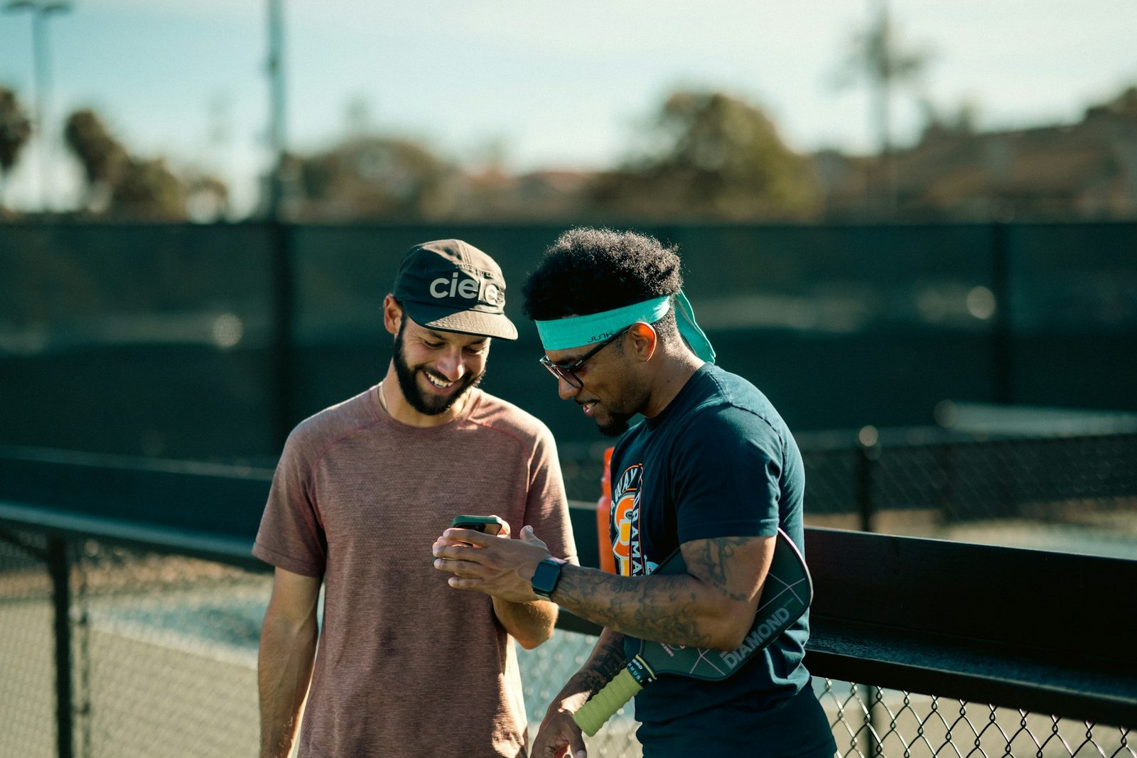 Two people standing together on a tennis court